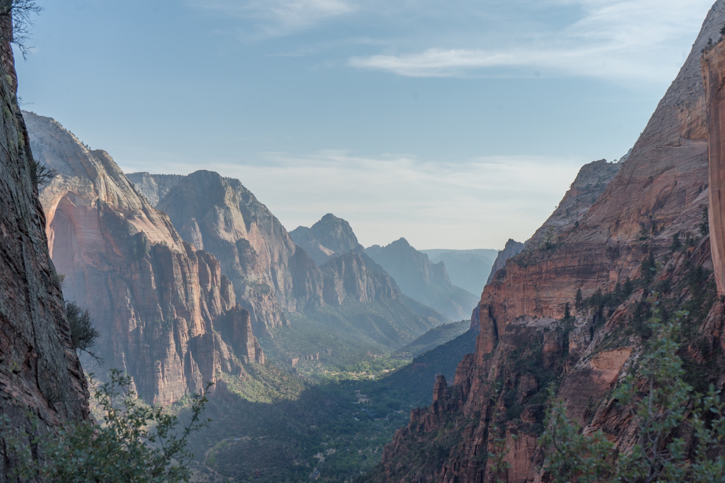 Wide view through a dramatic red-rock canyon valley