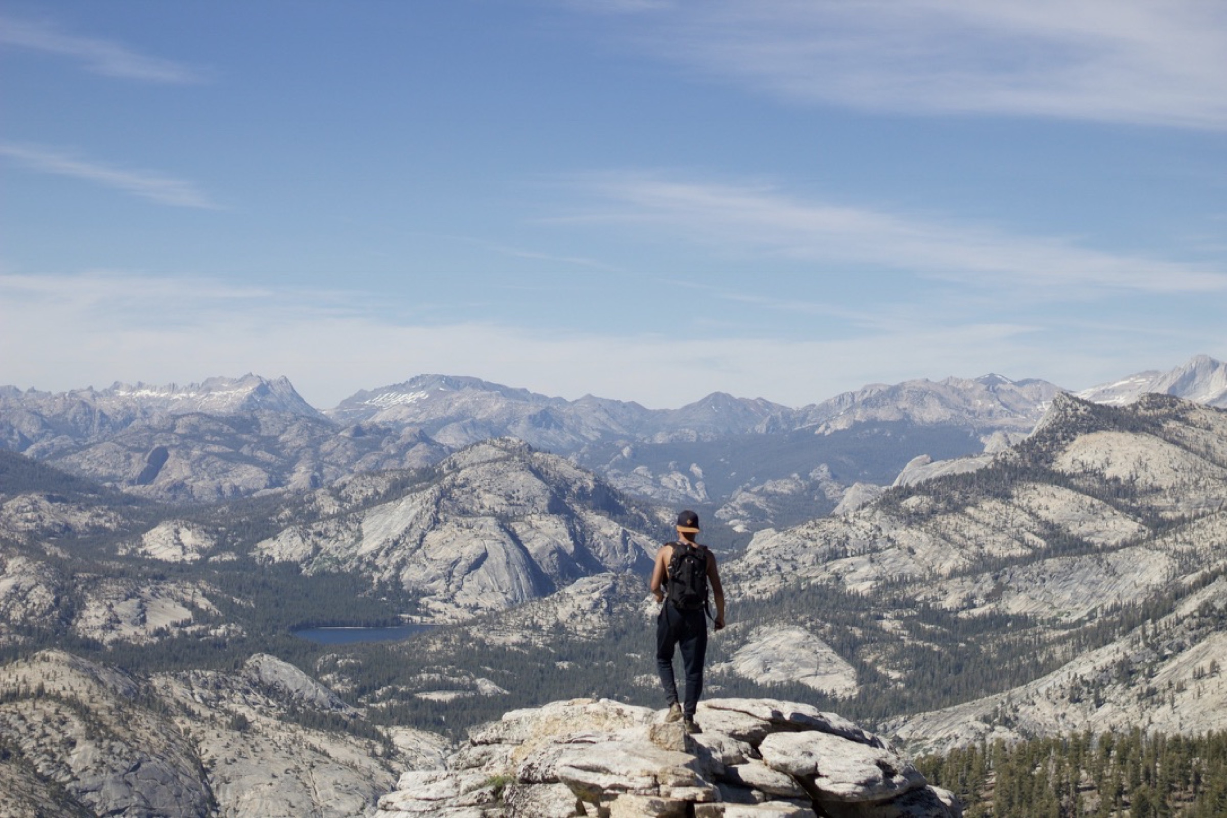A hiker looking across a wide mountain landscape